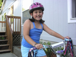 Girl wearing a helmet while riding her bike