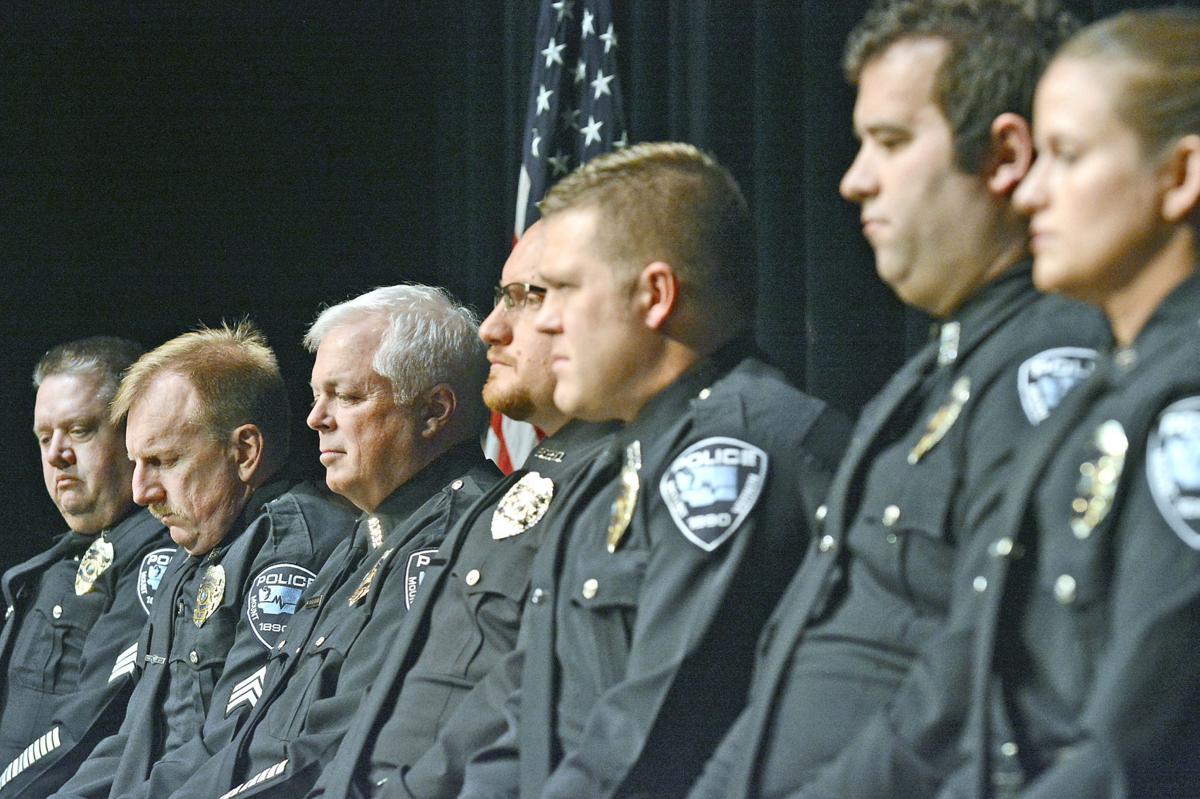 Mount Vernon and Burlington officers sit together during a ceremony honoring their response to a Mt 